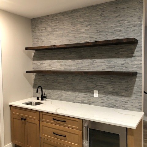 Happy Floors Wooden Sticks Mosaic in Silver adds texture to the backsplash, finished with TEC Power Grout in Dove Gray.