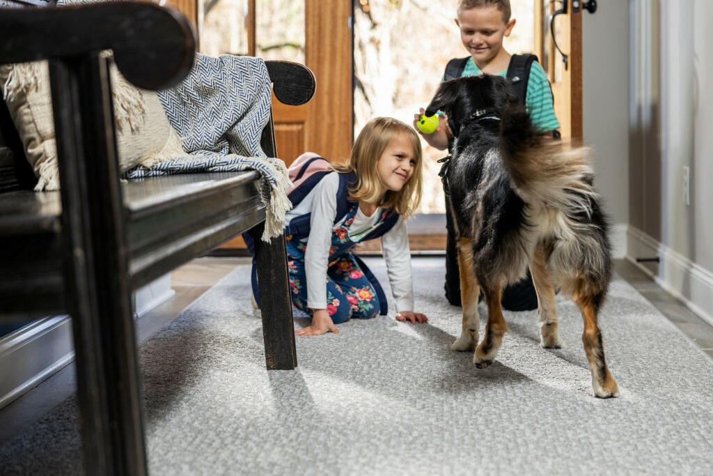 Kids playing with dog | Vallow Floor Coverings, Inc.